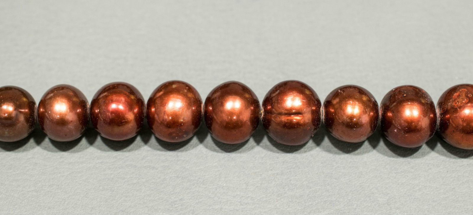 Perlenstrang Rostbraun rund mit hohem Lüster in 10-11 mm